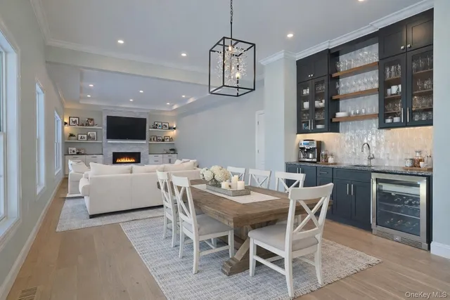 a dining room with stainless steel appliances kitchen island granite countertop a dining table chairs and view of kitchen