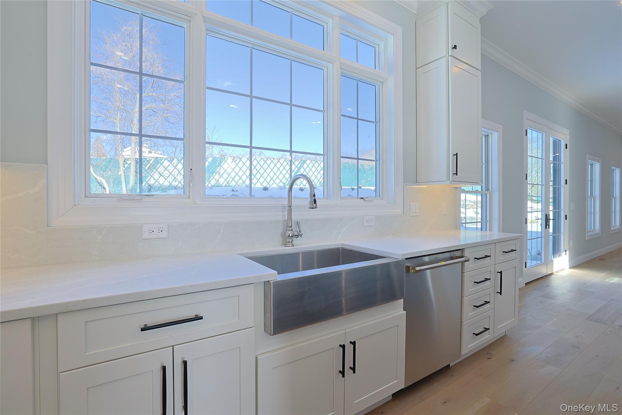 41 Croton Dam Road Ossining, NY 10562 - Photo 15 of 30 a kitchen with white cabinets and a sink