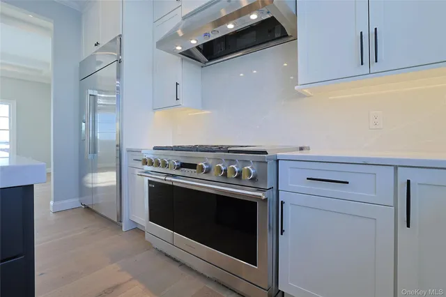 a stove top oven sitting inside of a kitchen