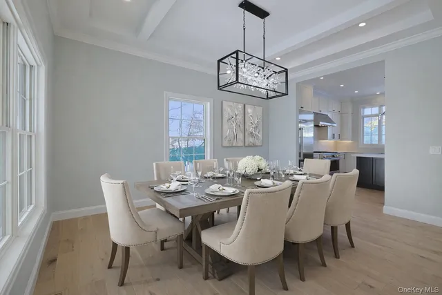 a view of a dining room with furniture wooden floor and chandelier