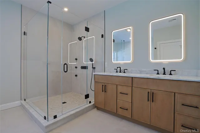 a bathroom with a shower sink and mirror
