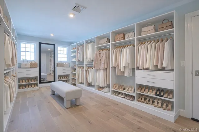 a spacious bedroom with a balcony a bed and a walk in closet