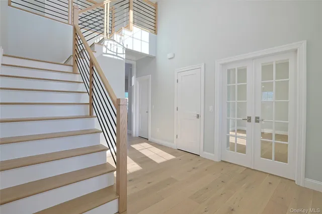 a view of entryway and hall with wooden floor