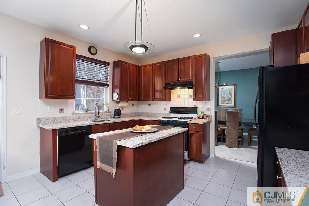 14 Timber Ridge Road North Brunswick, NJ 08902 - Photo 14 of 25 a kitchen with stainless steel appliances granite countertop a stove refrigerator sink and cabinets