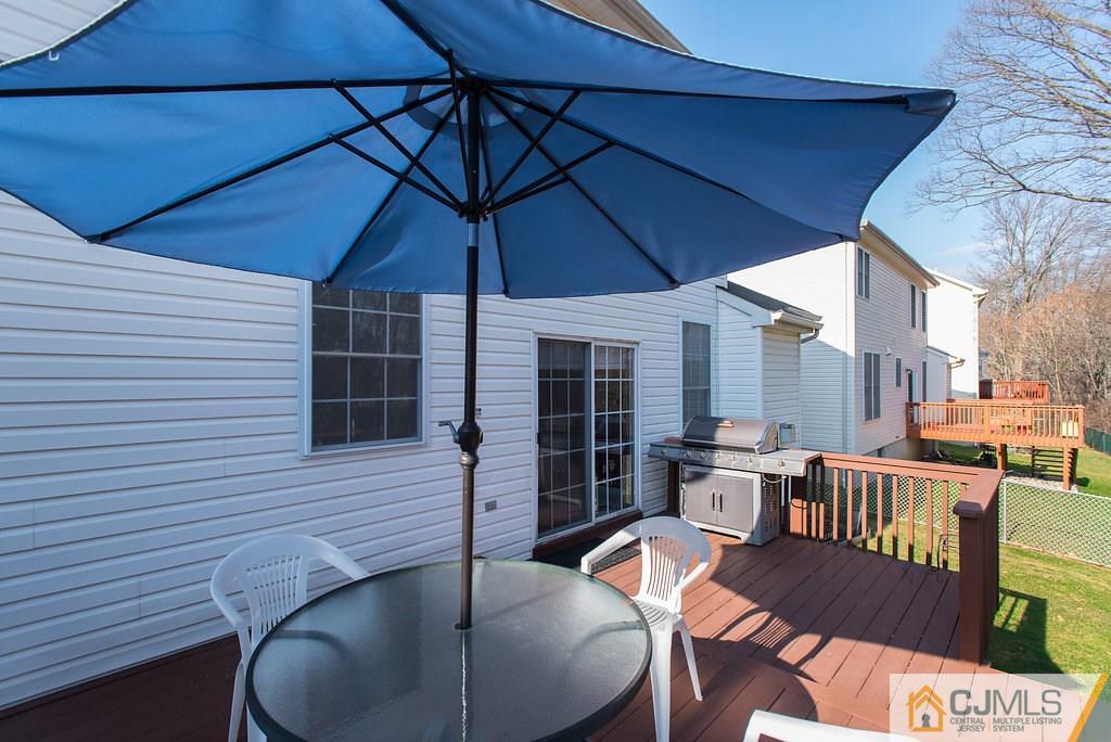 14 Timber Ridge Road North Brunswick, NJ 08902 - Photo 3 of 25 a patio with wooden table and chairs