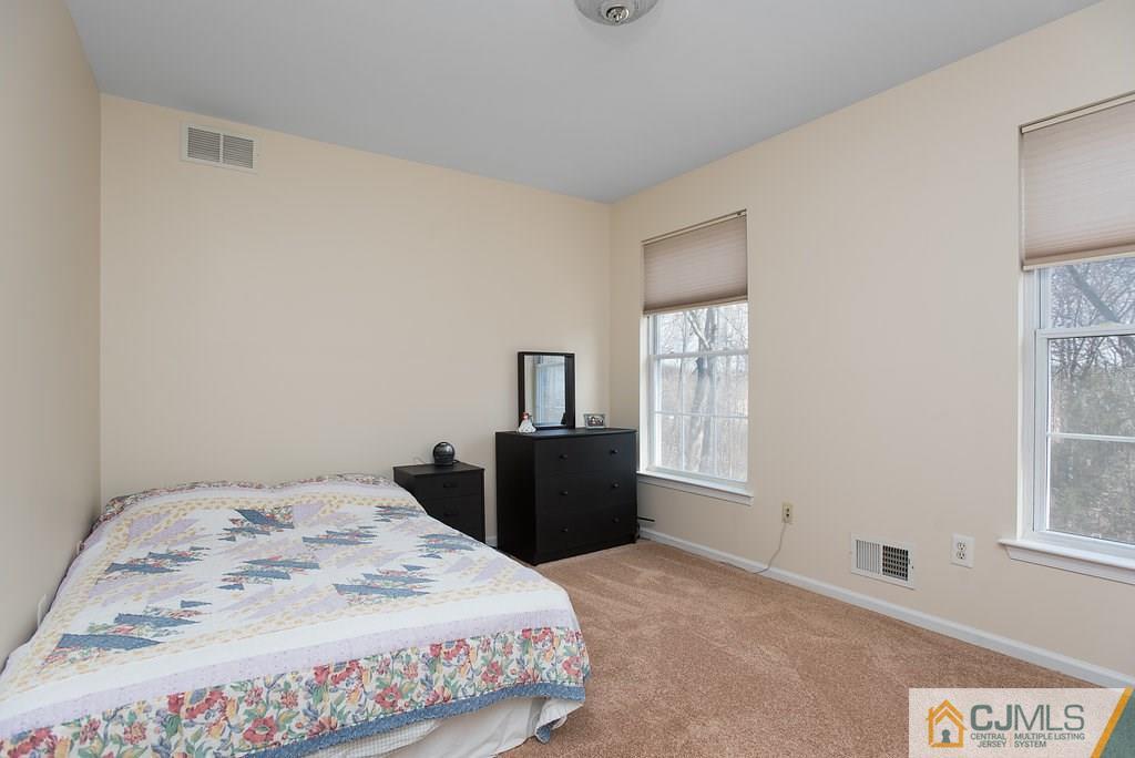 14 Timber Ridge Road North Brunswick, NJ 08902 - Photo 22 of 25 a bedroom with a bed and wooden floor