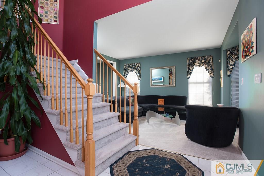 14 Timber Ridge Road North Brunswick, NJ 08902 - Photo 8 of 25 a living room with furniture and a potted plant