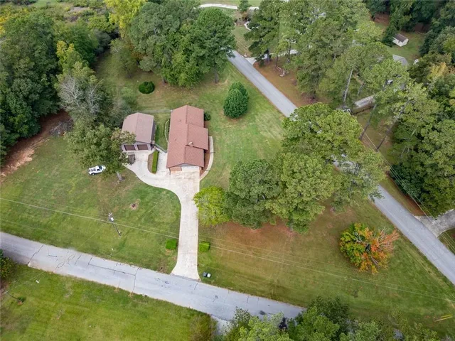 an aerial view of a house with a yard