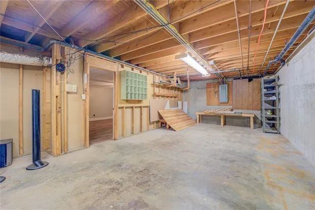 a backyard of a house with large trees and barbeque oven