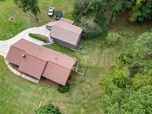 an aerial view of a house with pool