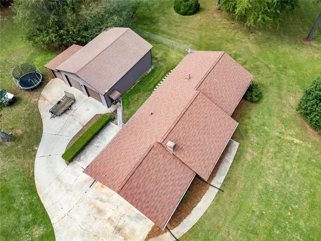 a view of a white house with a yard