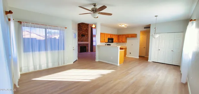 a view of a kitchen with a refrigerator a microwave and a sink