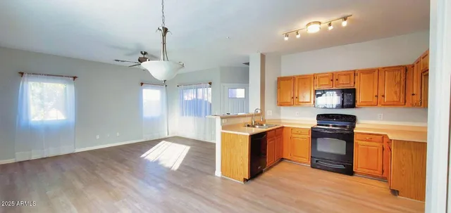 a kitchen with a stove a sink and a refrigerator