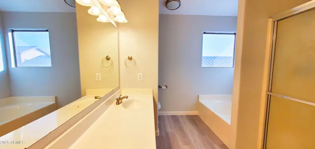 a bathroom with a tub and shower