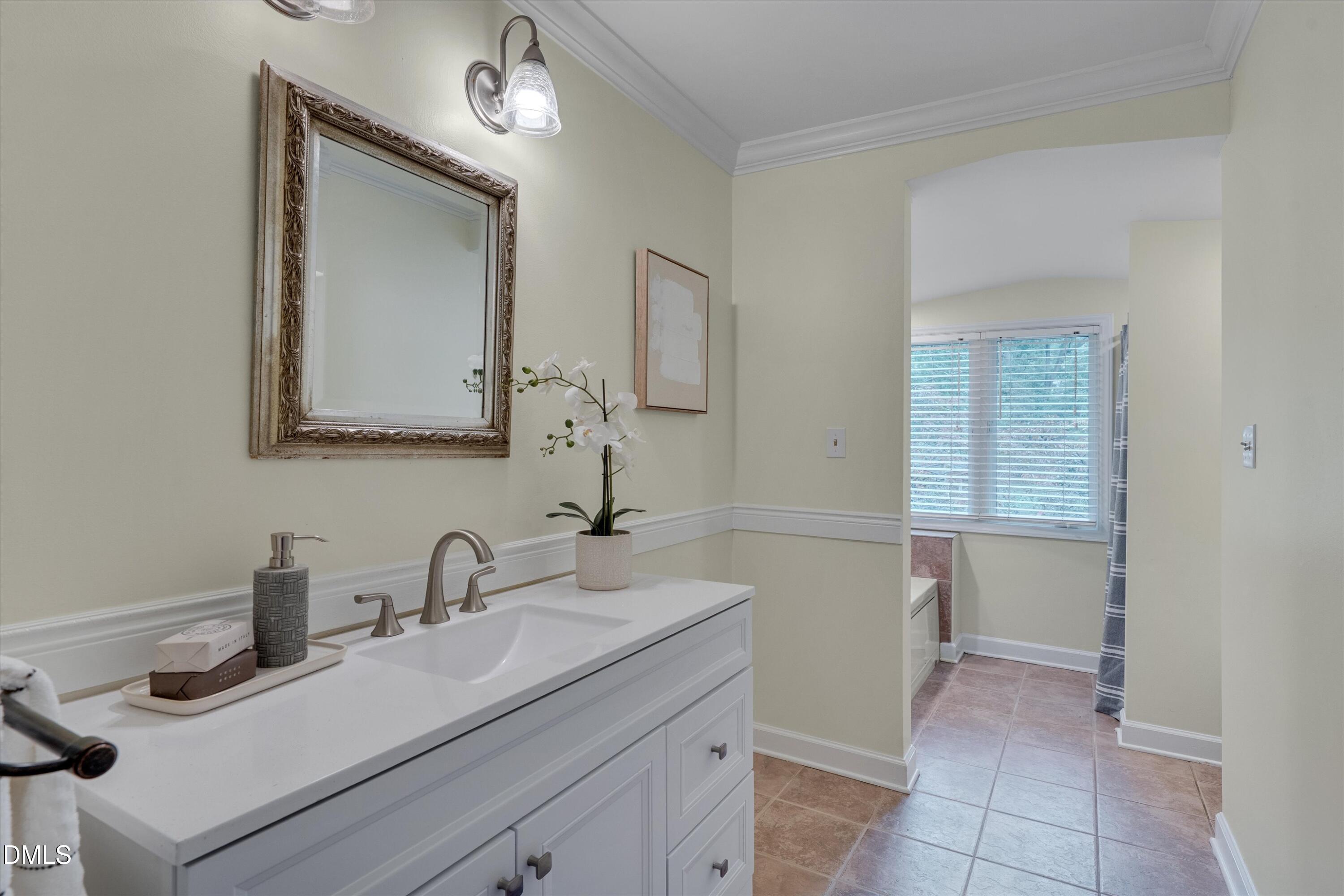 1617 Shawnee Street Durham, NC 27701 - Photo 12 of 56 a bathroom with a sink and a mirror
