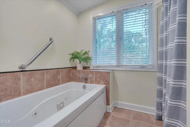 a bathroom with a bathtub and shower