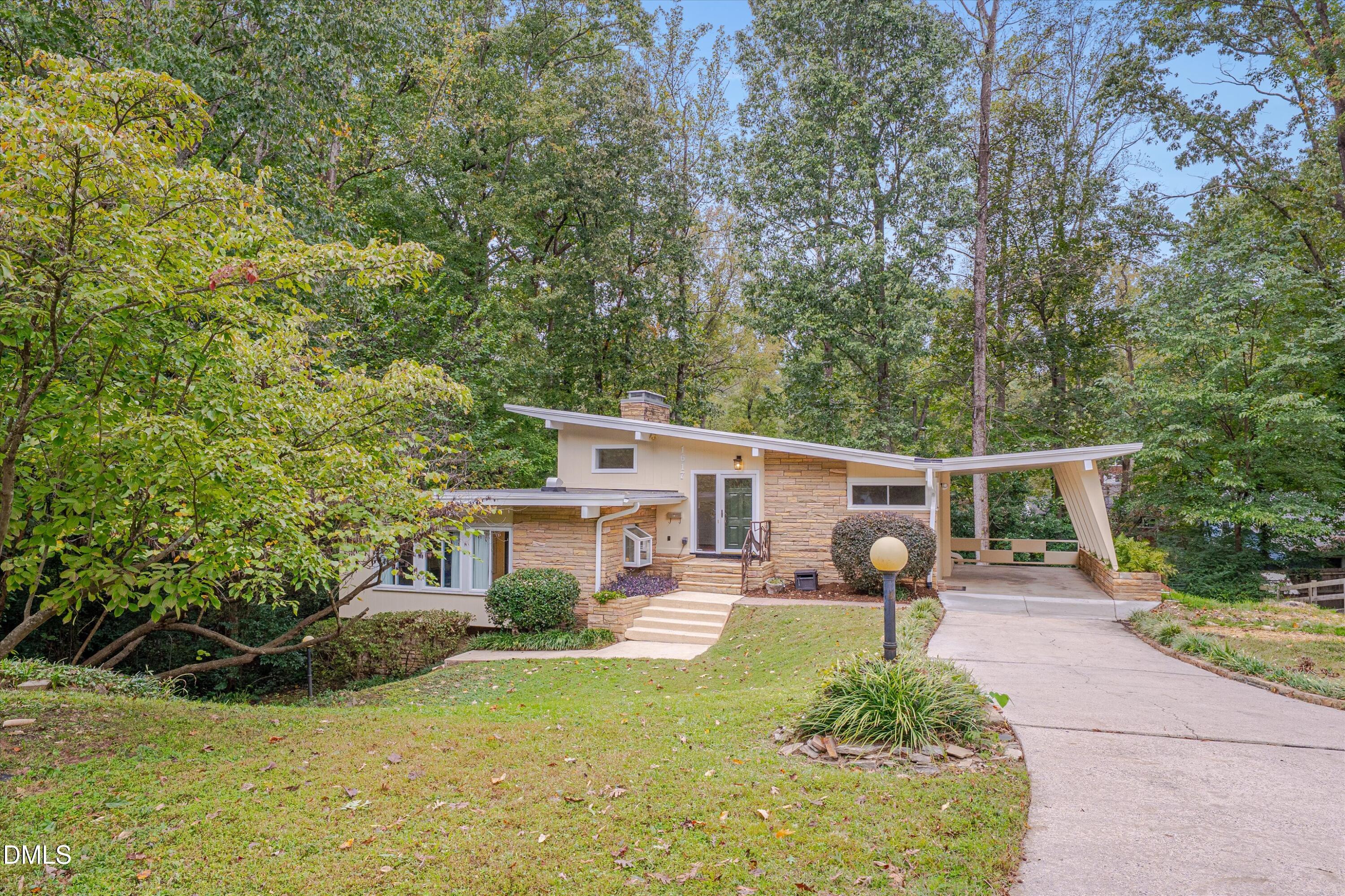 1617 Shawnee Street Durham, NC 27701 - Photo 2 of 56 a front view of a house with garden and sitting area