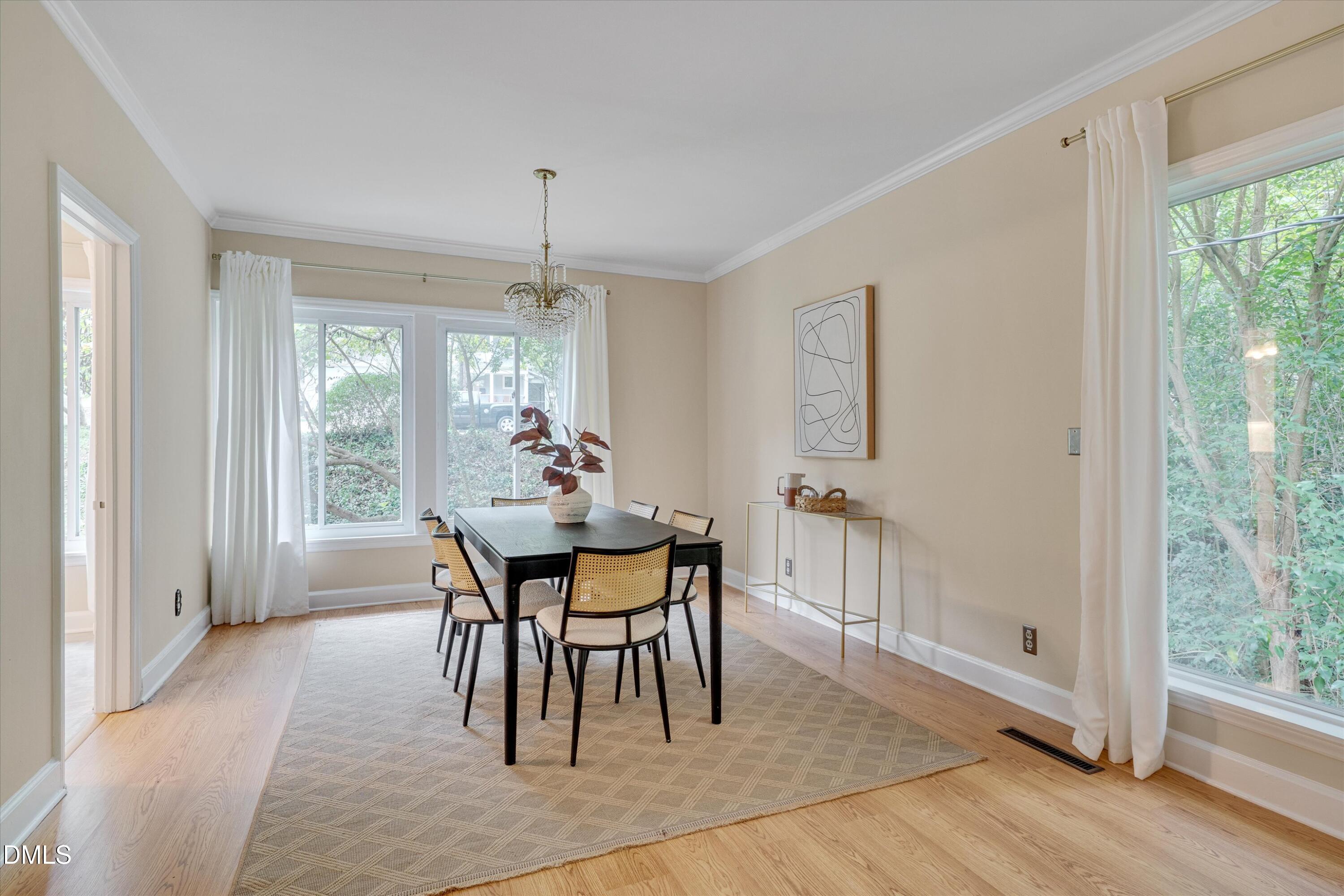 1617 Shawnee Street Durham, NC 27701 - Photo 24 of 56 a dining room with furniture a chandelier and wooden floor