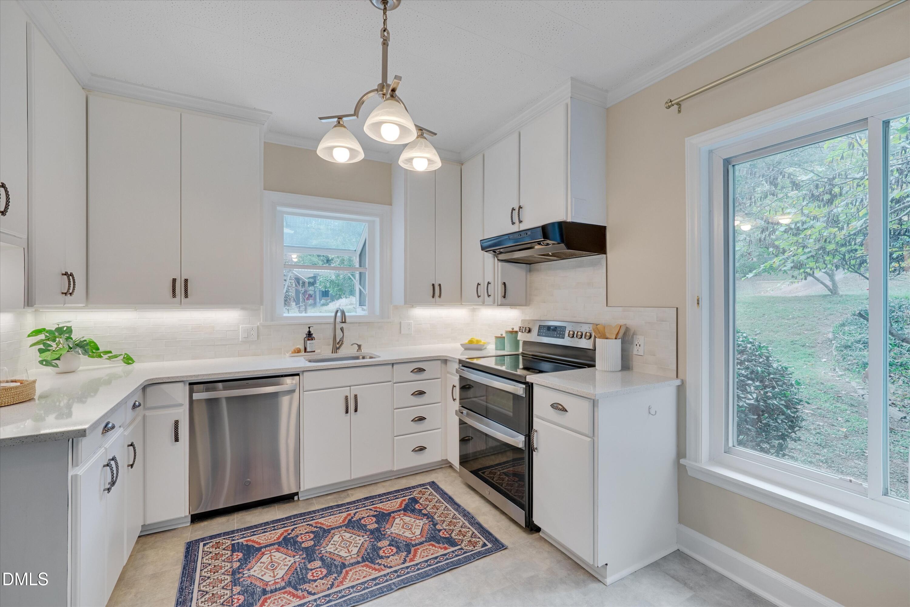 1617 Shawnee Street Durham, NC 27701 - Photo 26 of 56 a kitchen with a sink stove and wooden cabinets