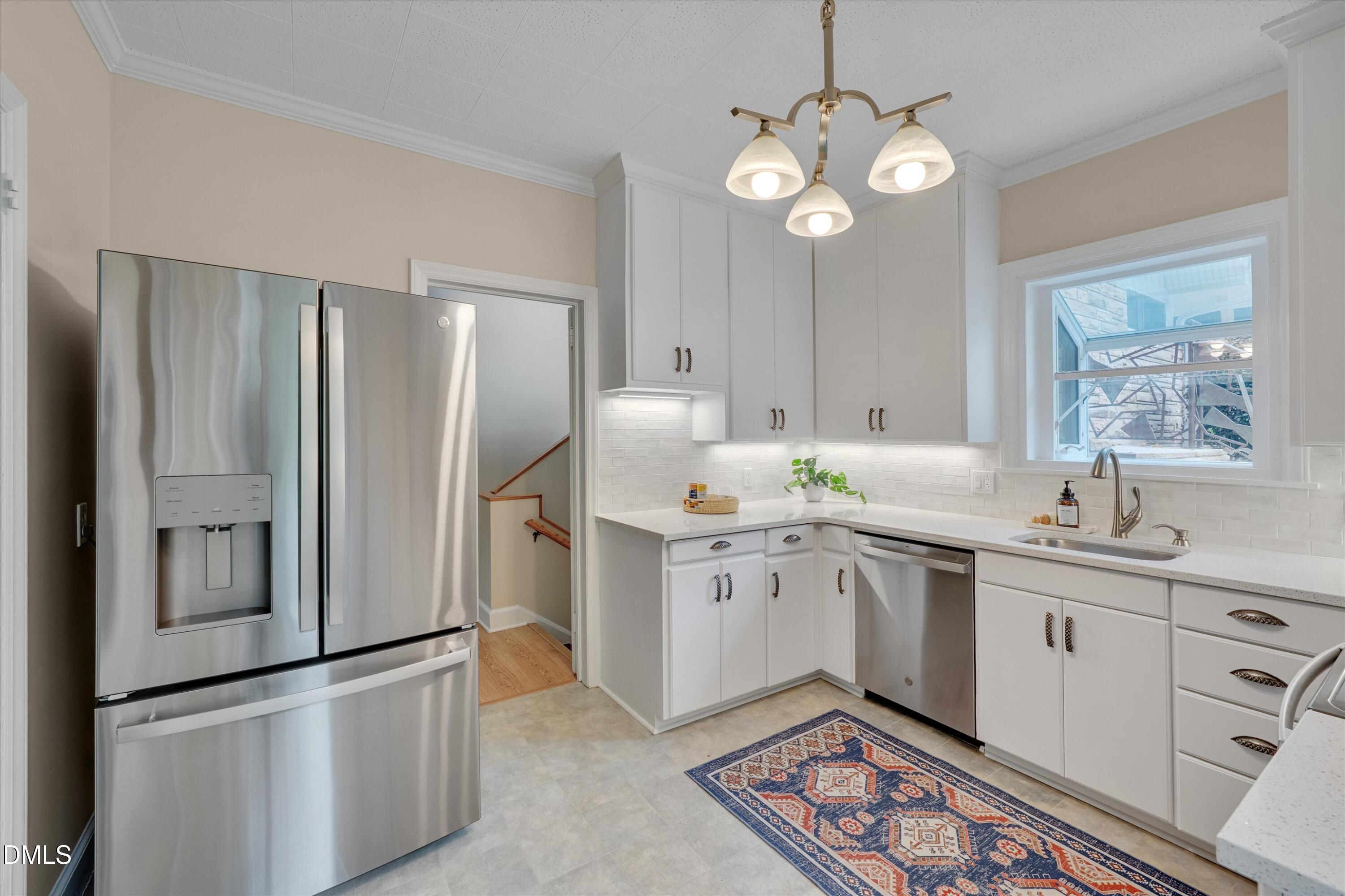 1617 Shawnee Street Durham, NC 27701 - Photo 28 of 56 a kitchen with stainless steel appliances granite countertop a sink a stove a refrigerator and island with wooden floor