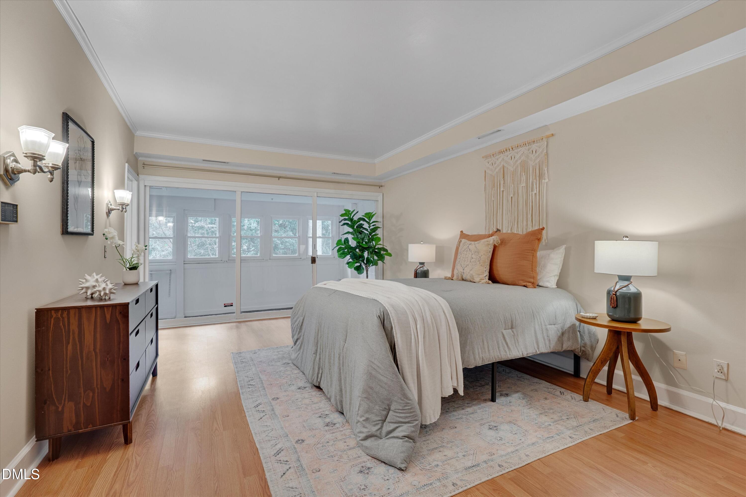 1617 Shawnee Street Durham, NC 27701 - Photo 31 of 56 a spacious bedroom with a bed and wooden floor
