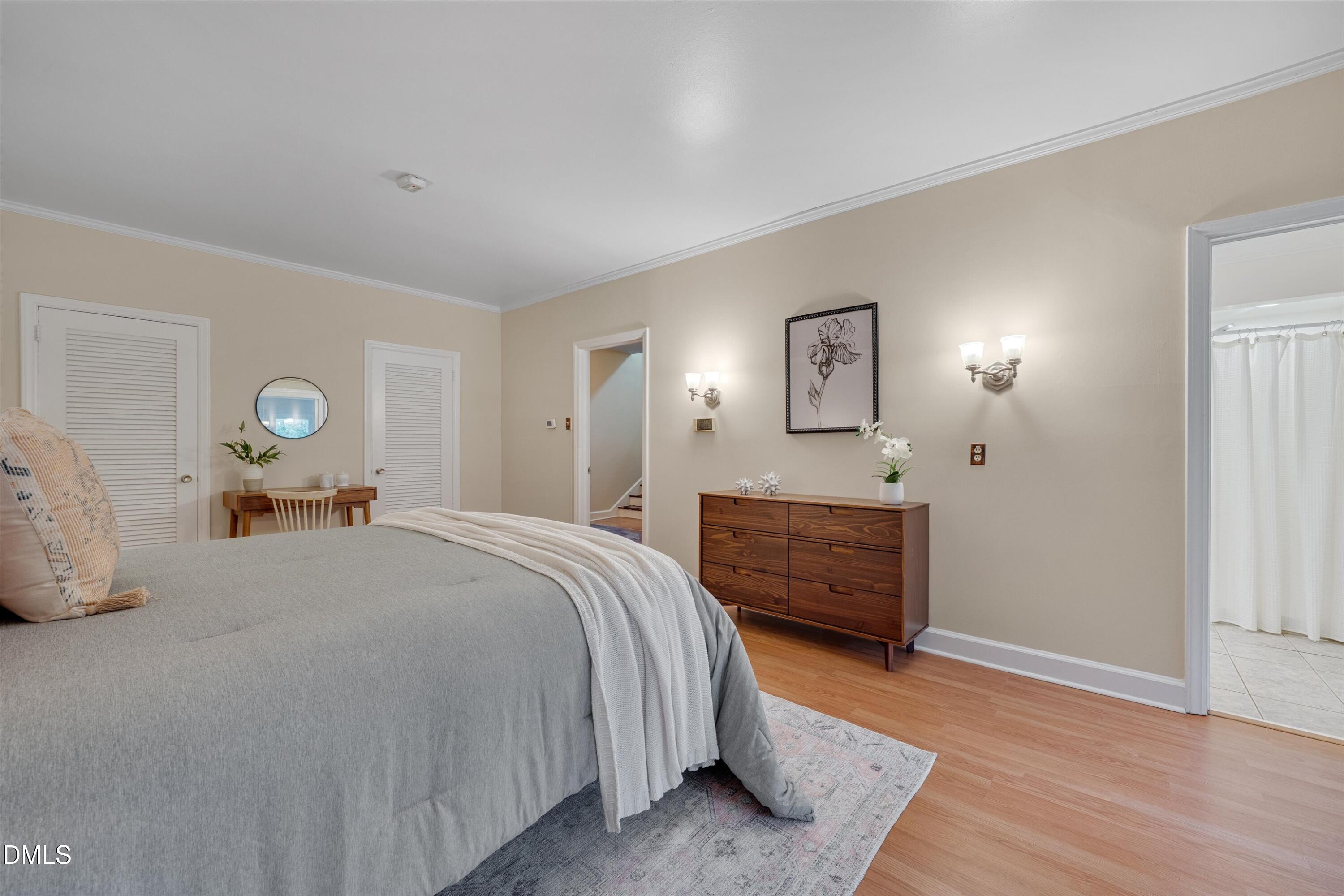 1617 Shawnee Street Durham, NC 27701 - Photo 32 of 56 a bedroom with a bed and wooden floor