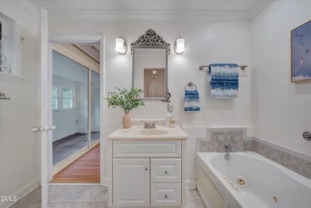 a bathroom with a bathtub sink and mirror