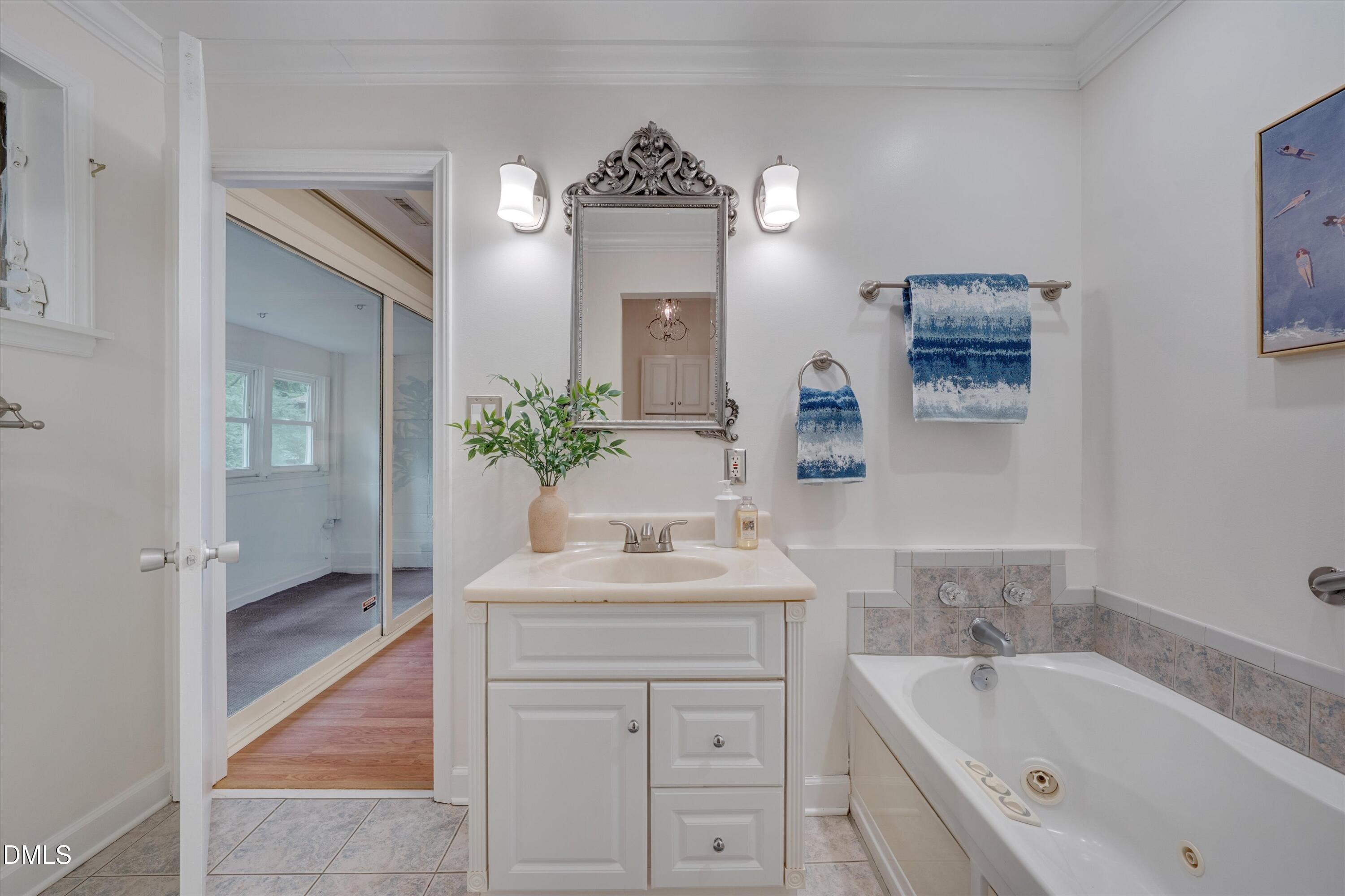 1617 Shawnee Street Durham, NC 27701 - Photo 33 of 56 a bathroom with a bathtub sink and mirror