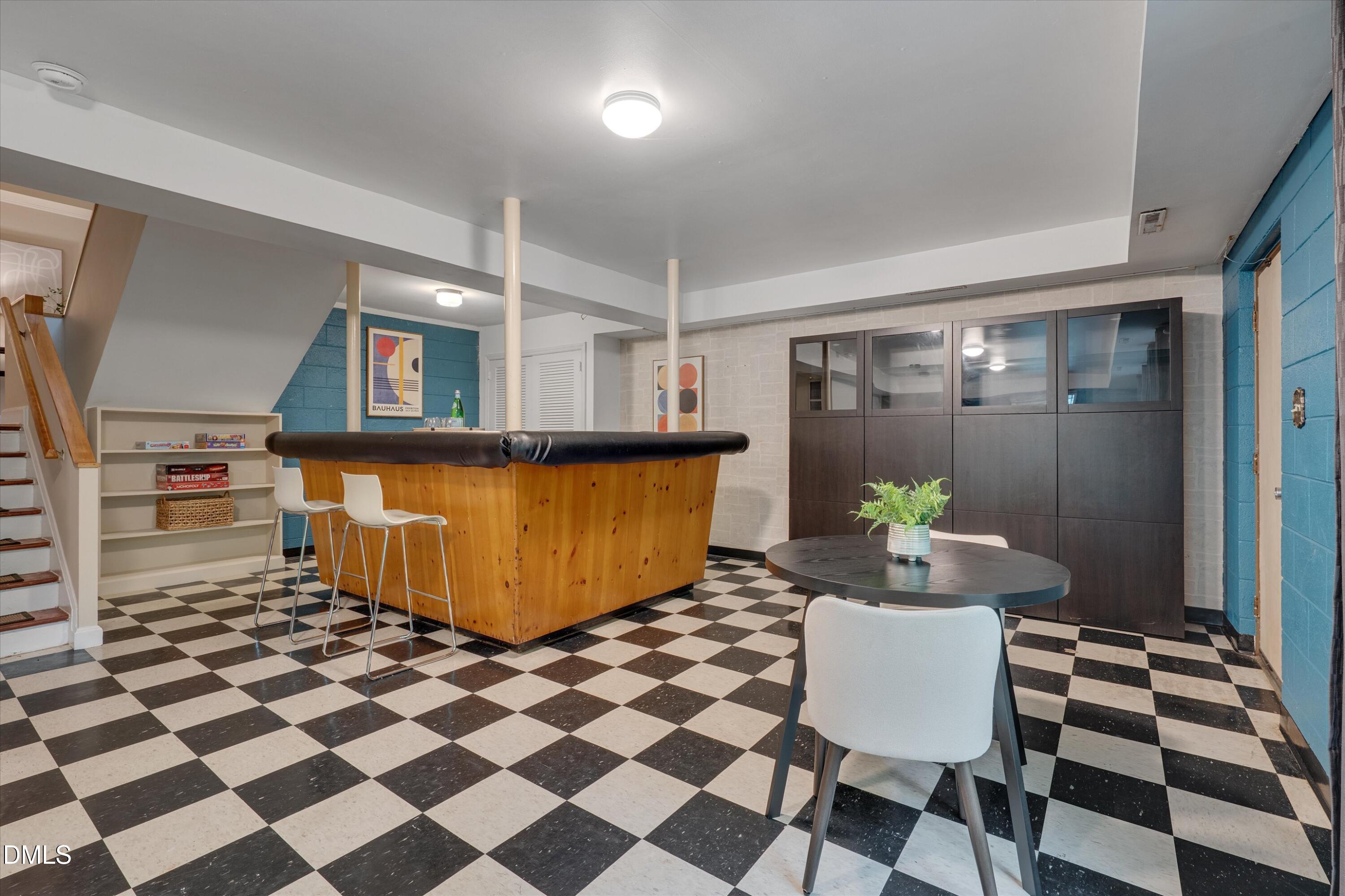 1617 Shawnee Street Durham, NC 27701 - Photo 41 of 56 a living room with a black white checkered floor with a dining table and chairs
