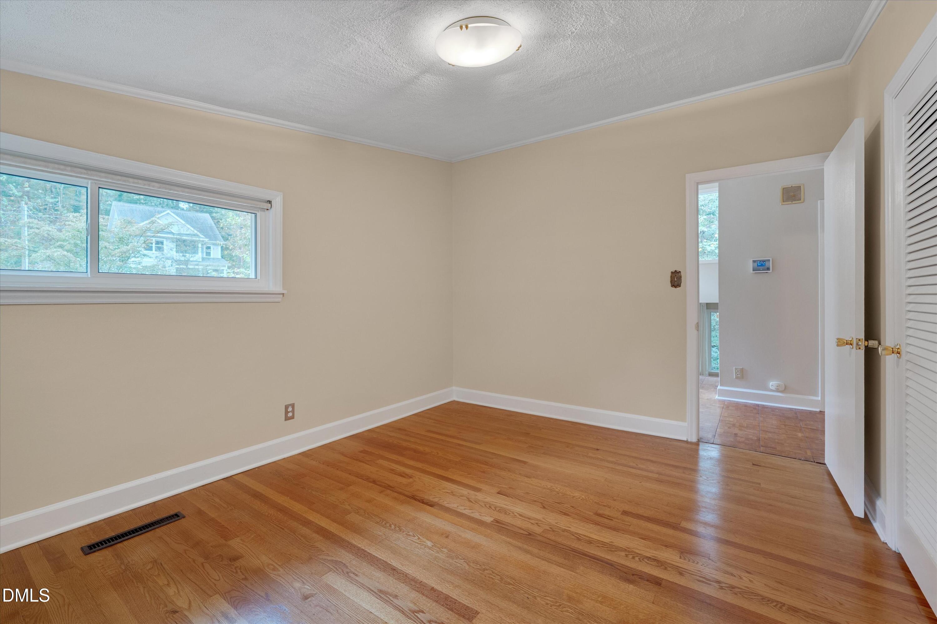 1617 Shawnee Street Durham, NC 27701 - Photo 9 of 56 an empty room with wooden floor and windows