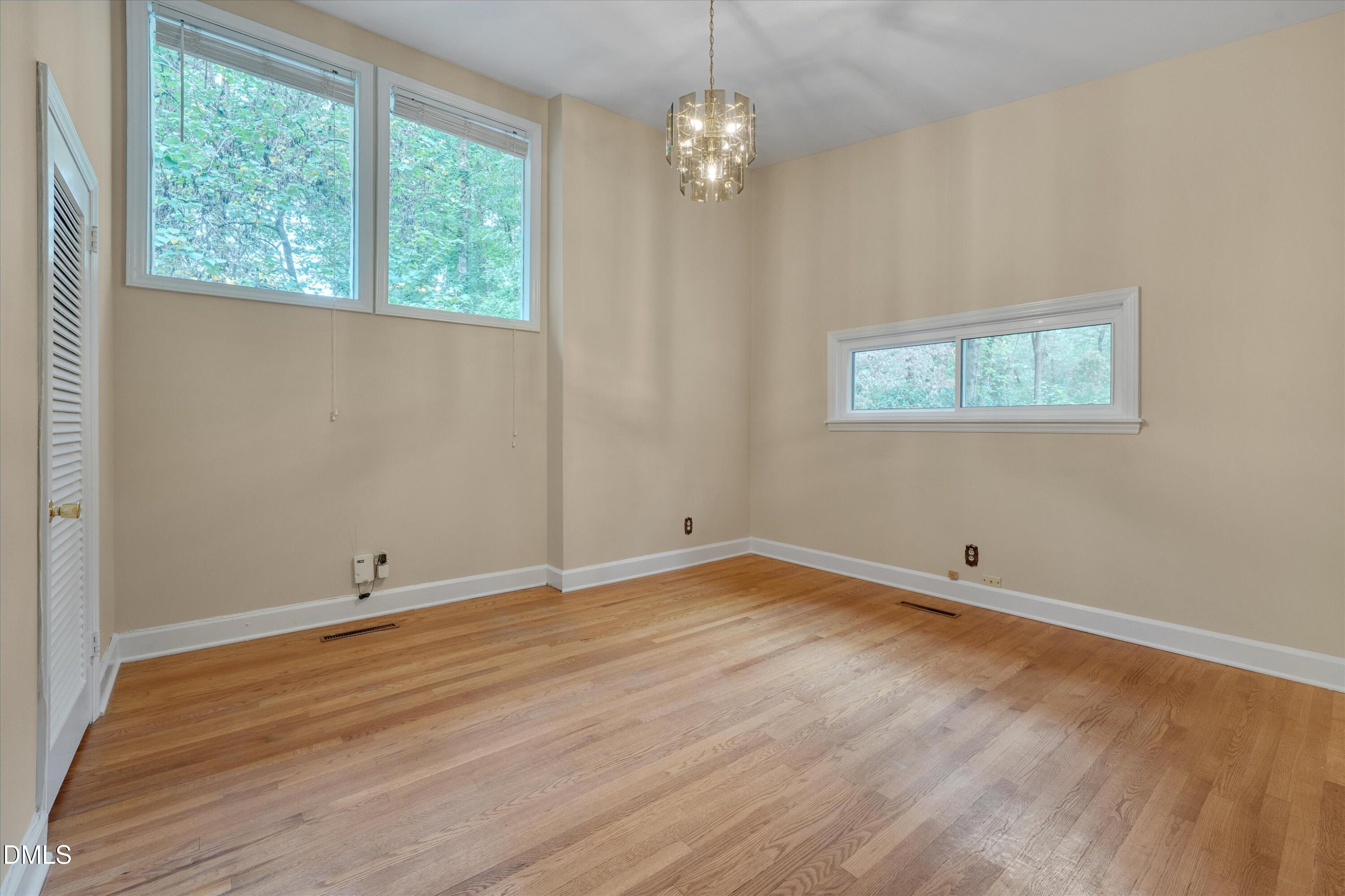 1617 Shawnee Street Durham, NC 27701 - Photo 10 of 56 an empty room with wooden floor and windows