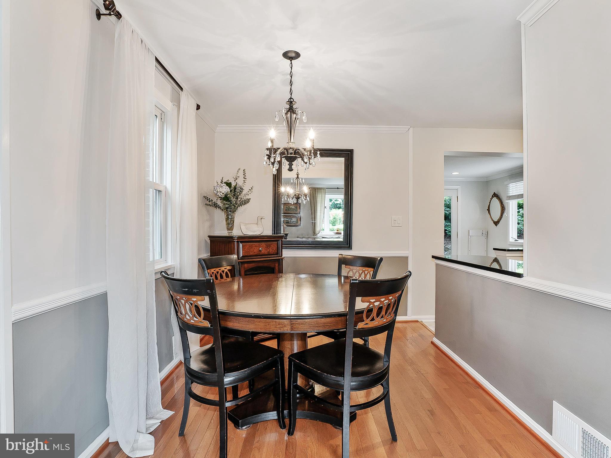 10205 Carson Place Silver Spring, MD 20901 - Photo 8 of 30 a dining room with furniture a chandelier and wooden floor