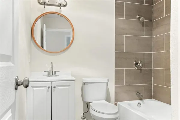 an empty room with a window and ceiling fan