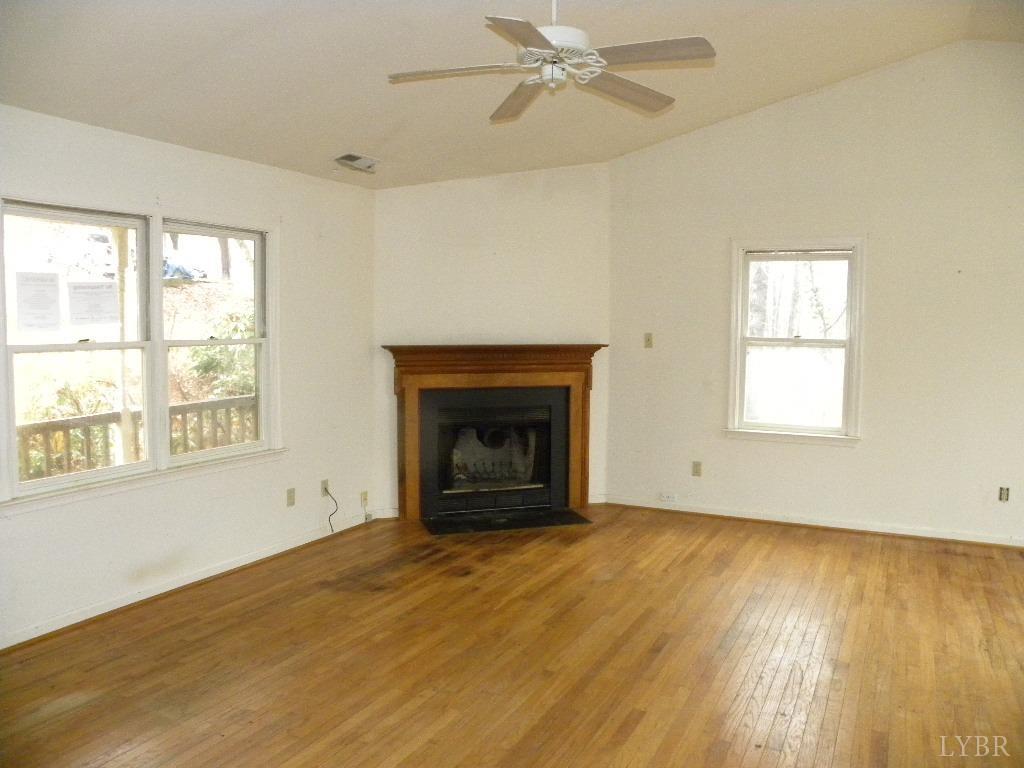 188 Petunia Road Ruckersville, VA 22968 - Photo 2 of 13 a view of an empty room with wooden floor fireplace and a window