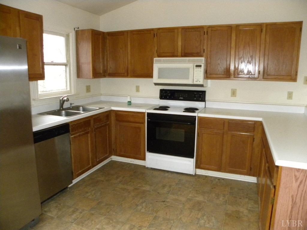 188 Petunia Road Ruckersville, VA 22968 - Photo 3 of 13 a kitchen with a sink stove top oven and cabinets
