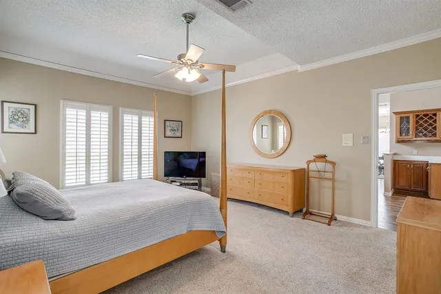 a bedroom with a bed a mirror and a window