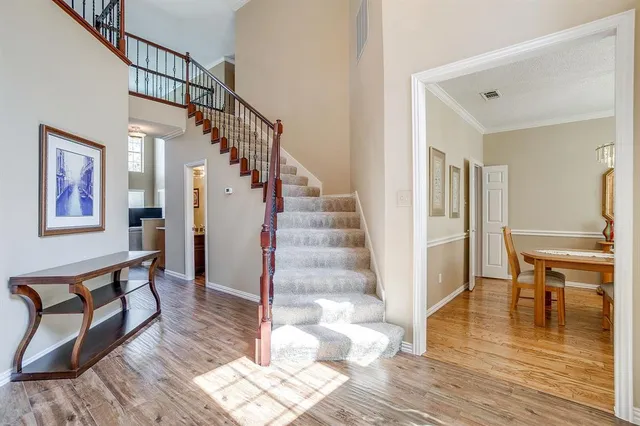 a view of entryway and hall with wooden floor