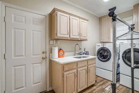 a utility room with sink dryer and washer