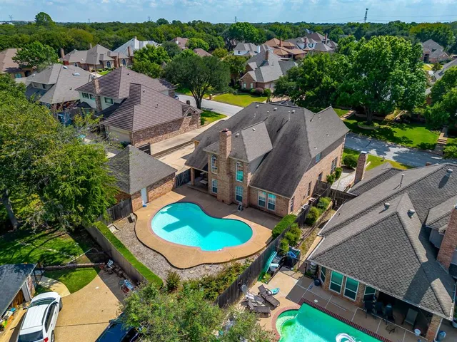 an aerial view of residential house with outdoor space and swimming pool