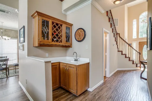 a view of a hallway with elevator and wooden floor