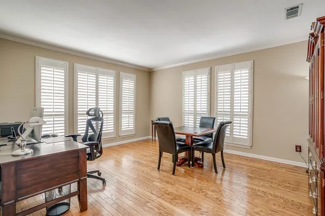 a dining room with furniture and wooden floor