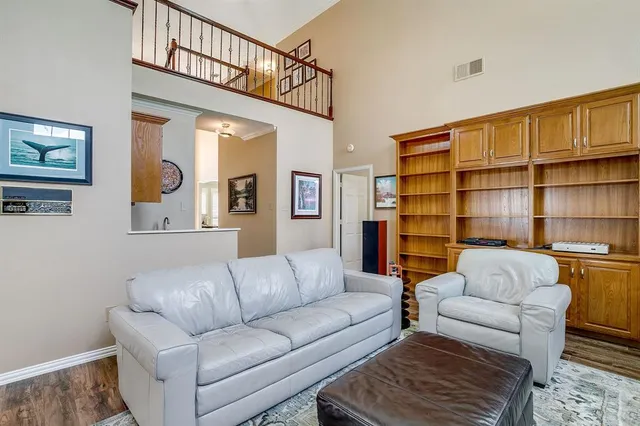 a living room with furniture a rug and a book shelf