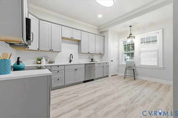 a kitchen with white cabinets sink and window