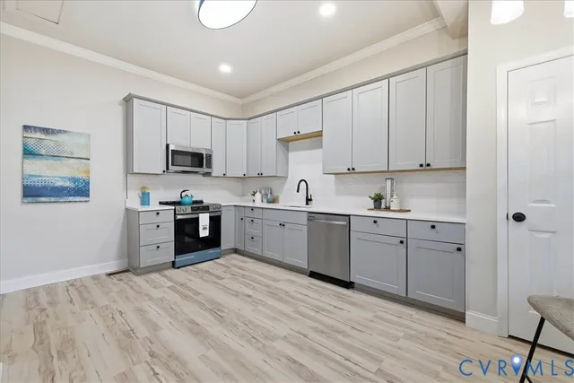 a kitchen with stove cabinets and a sink