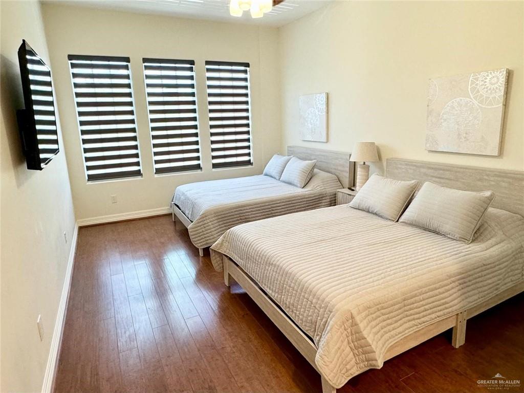 604 Rio Grande Avenue Mission, TX 78572 - Photo 13 of 17 Bedroom with dark hardwood / wood-style floors and multiple windows