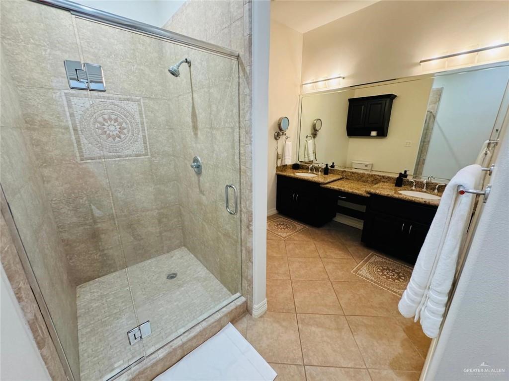 604 Rio Grande Avenue Mission, TX 78572 - Photo 10 of 17 Bathroom with tile floors, an enclosed shower, and double sink vanity