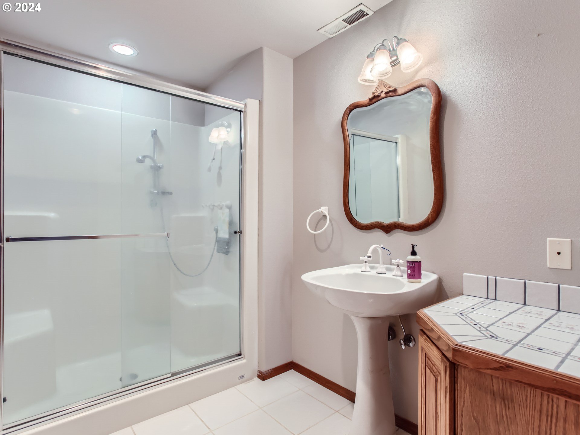1411 Northwest 211th Circle Ridgefield, WA 98642 - Photo 29 of 47 a bathroom with a sink vanity and a mirror