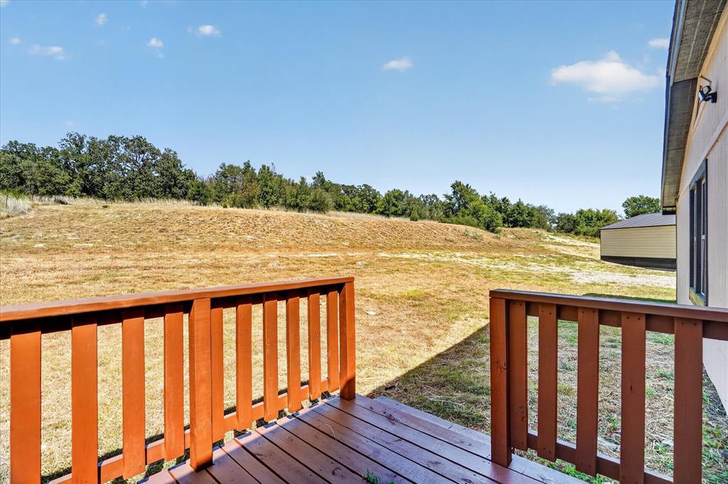 130 R&R Drive Springtown, TX 76082 - Photo 39 of 40 Wood-finish deck with a natural wood railing