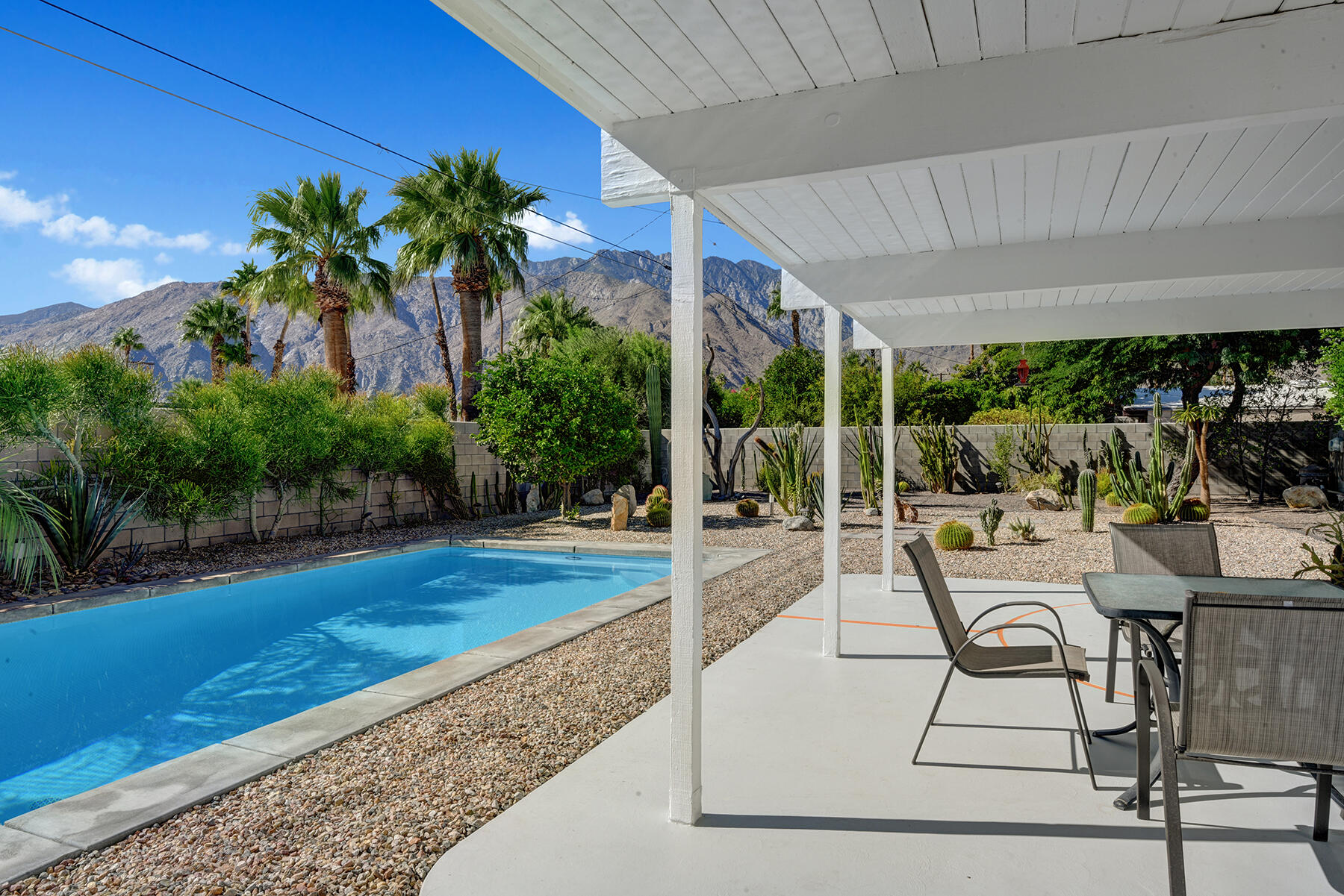 565 East Racquet Club Road Palm Springs, CA 92262 - Photo 29 of 38 BACK COVERED PATIO TO POOL AND MOUNTAINS
