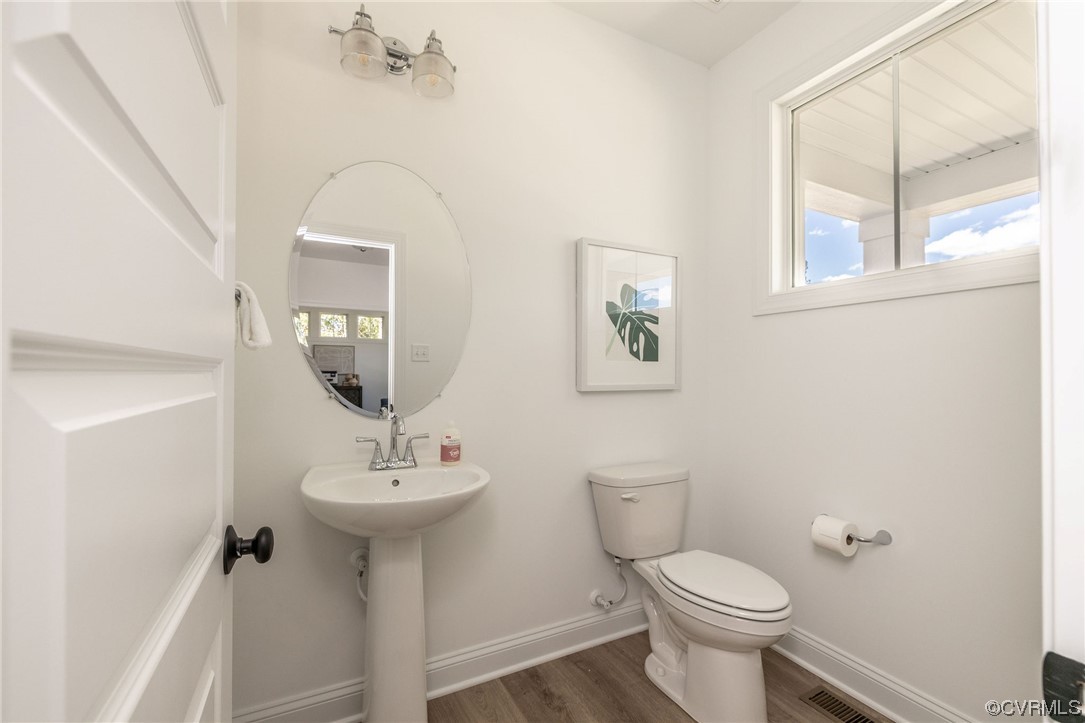 9107 Copplestone Road Chesterfield, VA 23832 - Photo 8 of 22 a bathroom with a toilet sink and mirror